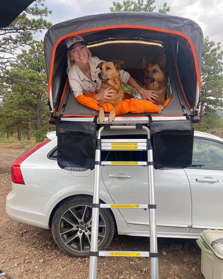 Roofnest Meadowlark  roof top tent with lady and two dogs