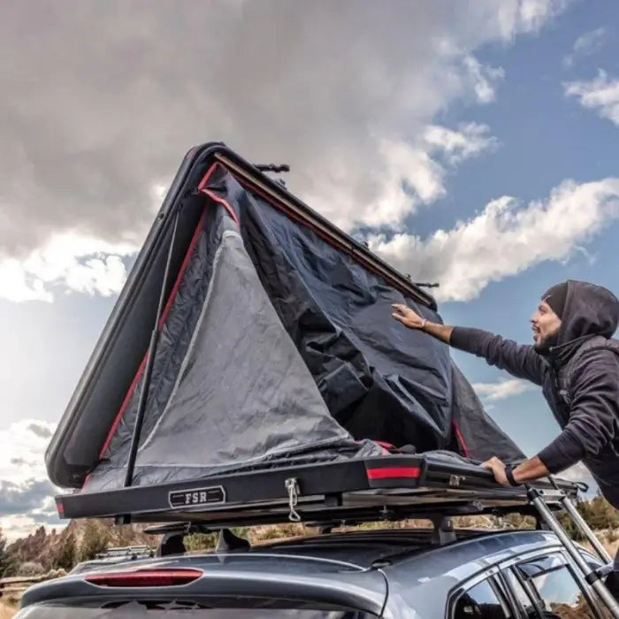 Freespirit Odyssey Roof Top Tent about be opened by a person