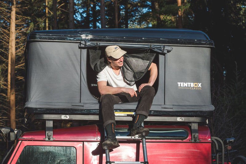 TentBox Classic Roof Top Tent with a man in front
