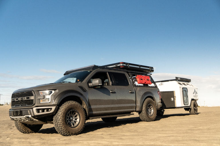 CBI Ford Raptor with a Bed Rack and a trailer