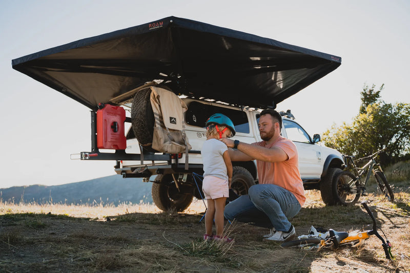 Father and son under Roam ARC 270 Awning