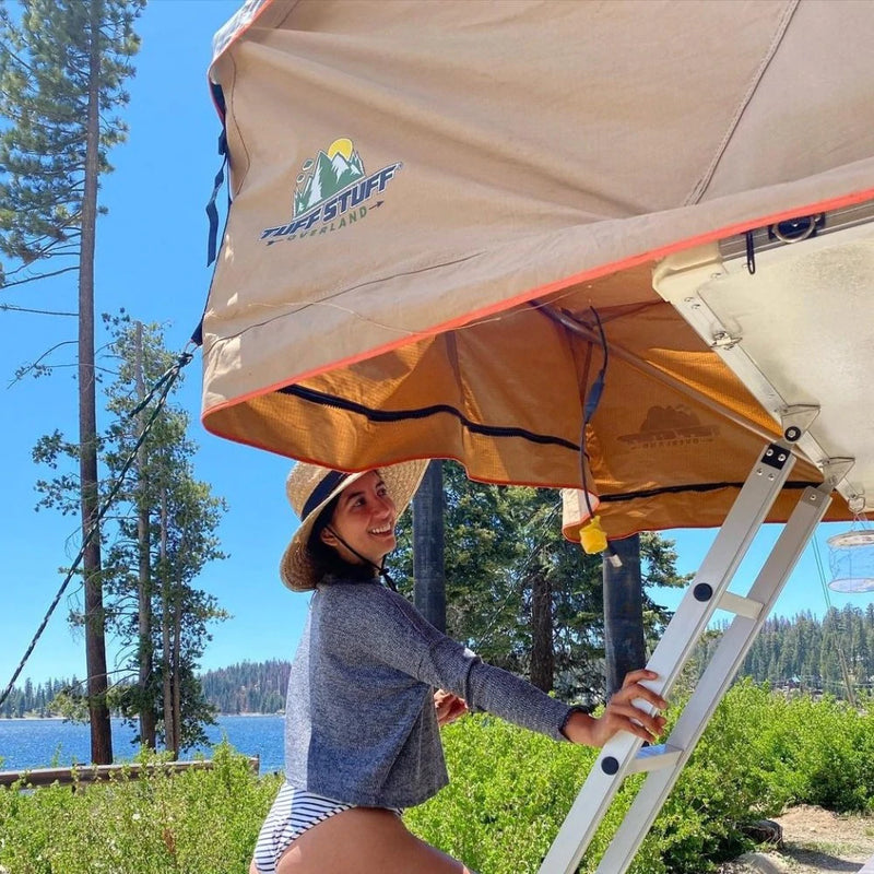 Girl using ladder to get inside Tuff Stuff Ranger Roof Top Tent